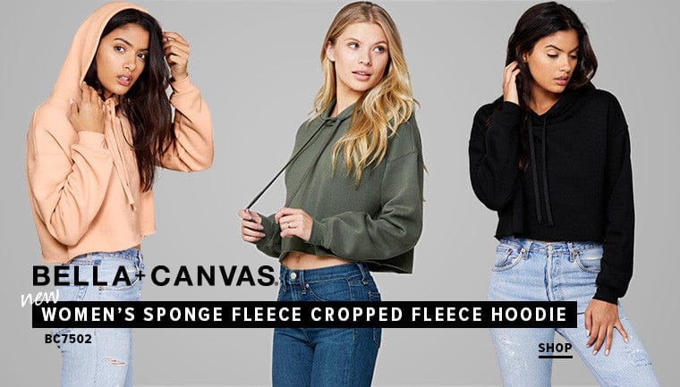 Three women wearing Bella+Canvas women's sponge fleece cropped fleece hoodies on a gray background.