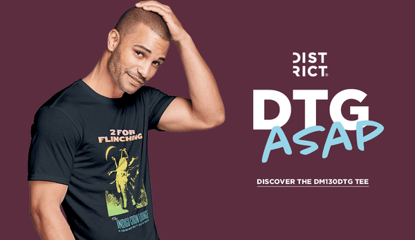 Man wearing a black t-shirt with graphic design on a purple background featuring 'District DTG ASAP' text.