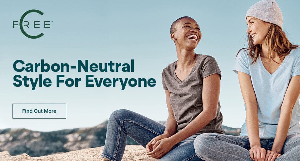 Two people sitting on a rock with a clear blue sky, promoting carbon-neutral style.