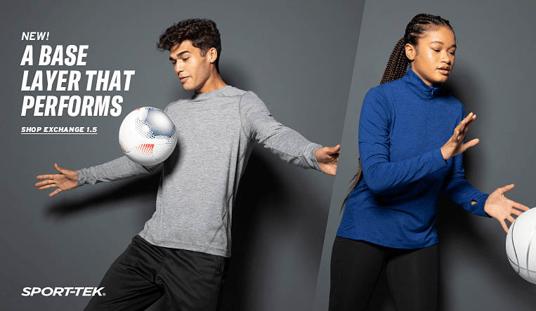 Two people wearing Sport-Tek base layers with volleyballs, promoting a new product.